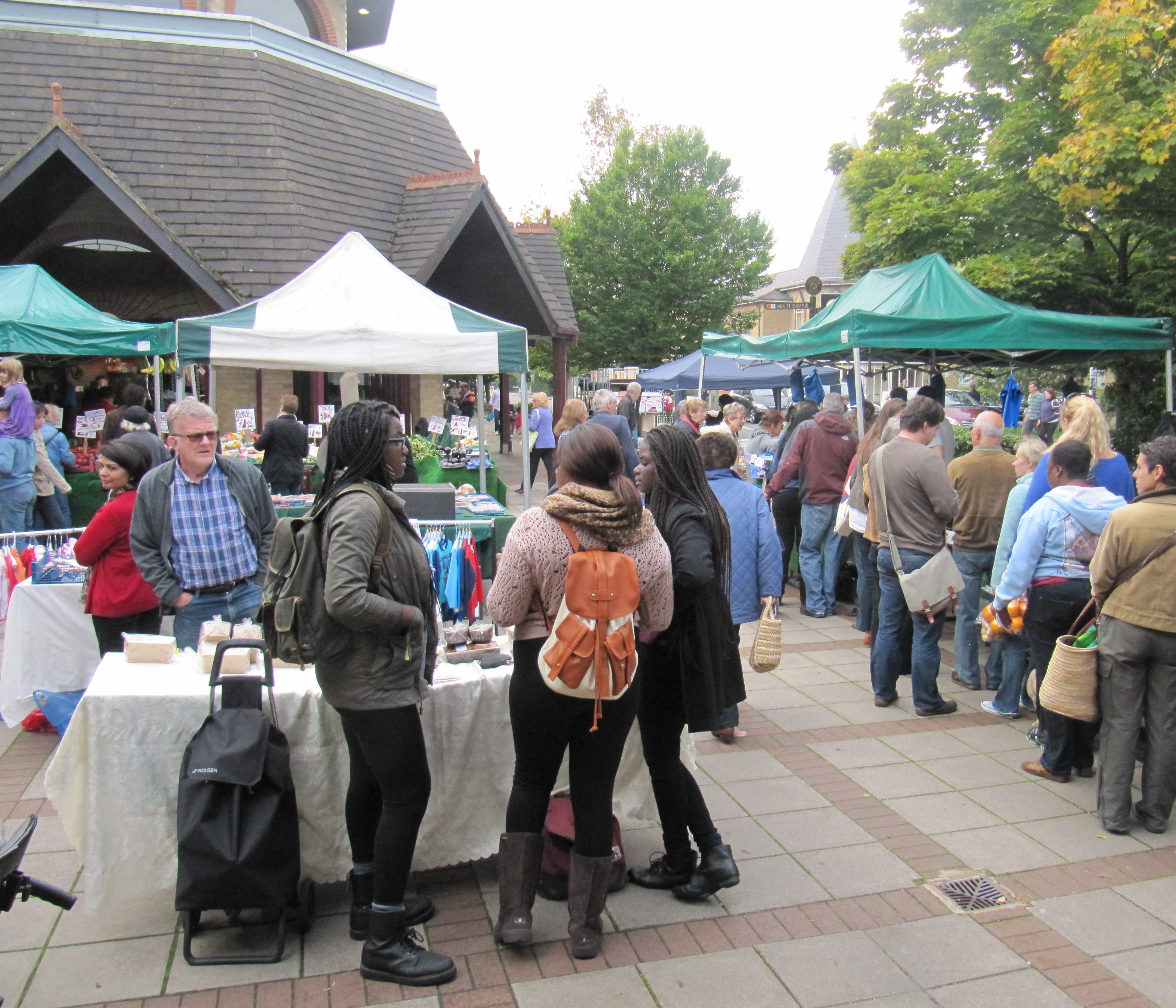 Shoppers in Barnet Market with stalls outside Waitrose